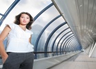 Confident young businesswoman in futuristic interior.