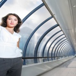 Confident young businesswoman in futuristic interior.