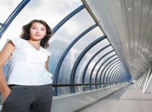 Confident young businesswoman in futuristic interior.